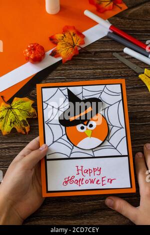 Greeting card for Halloween on a wooden table. Childrens art project, handmade, crafts for children. Stock Photo