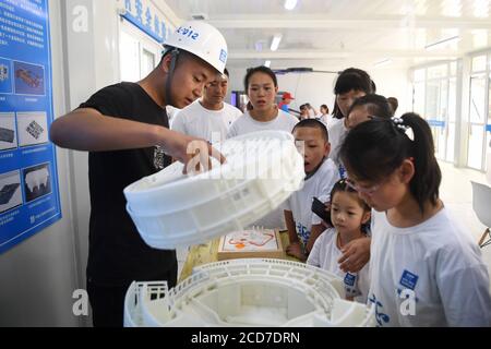 (200827) -- LANZHOU, Aug. 27, 2020 (Xinhua) -- A staff member of the China Construction Third Engineering Bureau Co., Ltd. displays 3D printing model during a caring activity in Anning District of Lanzhou, northwest China's Gansu Province, Aug. 27, 2020. A caring activity for left-behind children in rural areas was held at a construction site of a women and children's hospital in Lanzhou on Thursday. Experts and volunteers conducted safety knowledge education to children and communicated with parents who are migrant workers here on family education and communication between parents and childr Stock Photo