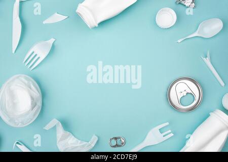 Plastic frame of white garbage with copy space on blue background, flay lay. Stock Photo