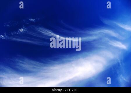 Mares tails high cirrus clouds against deep blue sky Stock Photo