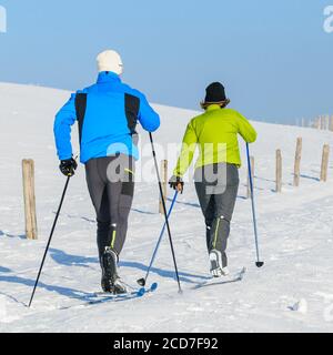 Couple making a relaxed tour in nature with nordic cruising skis Stock Photo
