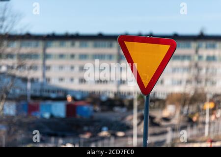 Give way sign in front of a housing complex. Stock Photo