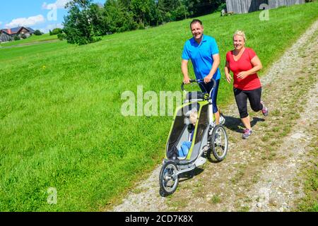 Sporty family doing a jogging session in beautiful landscape Stock Photo