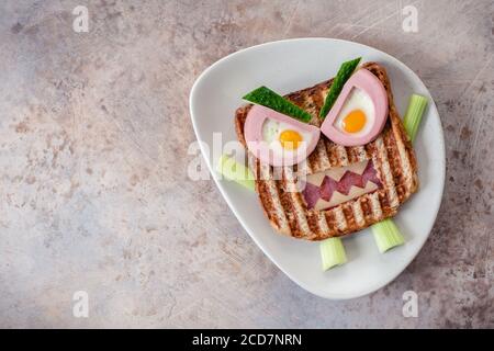 Monster sandwich with sausage, eggs and cheese on plate. Stock Photo