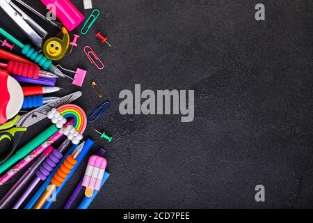 School supplies on black board background with copy space. Back to school concept Stock Photo