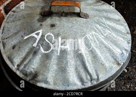 close up of Ash only metal dustbin lid, also known as waste bin outside in sunshine Stock Photo
