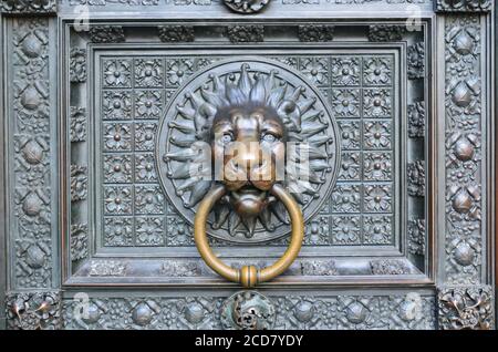 Bronze knocker in the shape of a lion head from the gate of the Cologne Cathedral, Germany Stock Photo