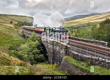 The 'Royal Scot' steam locomotive hauls 'The Fellsman' train on the Settle-Carlisle railway line at Ais Gill viaduct, Kirkby Stephen, Cumbria.. Stock Photo