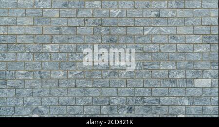 wall is lined with gray marble tiles. Stock Photo