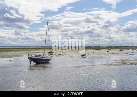 Single boat on the beach at low tide. Focus on boat. Leigh on Sea, Essex Stock Photo