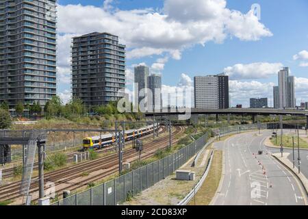 Train tracks in Stratford with a London Overground train. Skyscrapers of Stratford City in the background. London Stock Photo