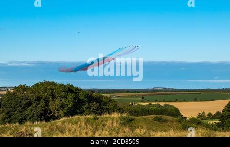 The Royal Air Force RAF Aeronautics Display Team or Red Arrows fly over  East Lothian on a sunny Summer day with clear blue sky,  Scotland, UK Stock Photo