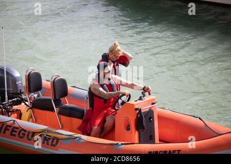 Two lifeguards cast off in a ribcraft in Brighton Marina, East Sussex Stock Photo