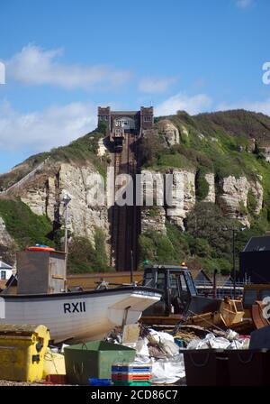 Fishing boats on the shingle beach of Hastings Harbour in front of the East Hill funicular railway in Hastings, Sussex, England, UK. Stock Photo