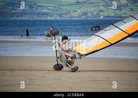 young woman driving blokart at speed tipping over compact land yachts on benone beach northern ireland uk Stock Photo
