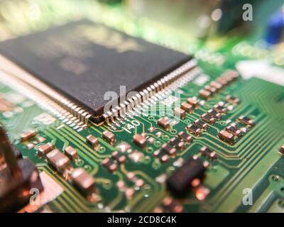 The electronic circuit board with electronic components such as chips close up. Stock Photo