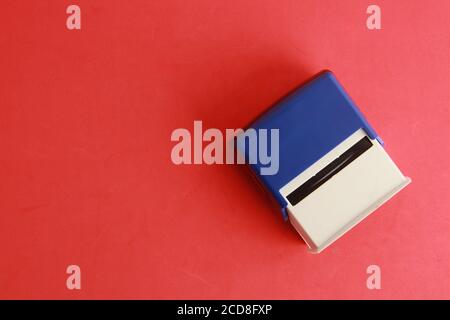 Overhead shot of an automatic ink stamp manufactured in blue plastic Stock Photo