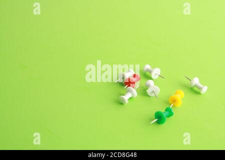Close up shot of plastic thumbtacks in colorful background Stock Photo