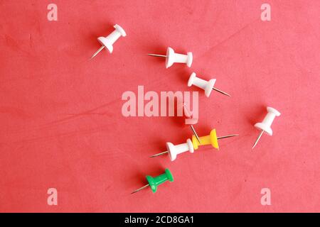 Close up shot of plastic thumbtacks in colorful background Stock Photo