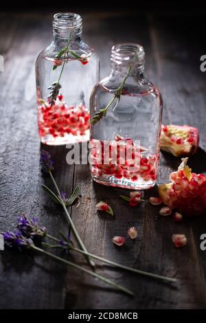 Water with pomegranate seeds in a bottle.Healthy breakfast.Sweet drink.Delicious food and dessert. Stock Photo