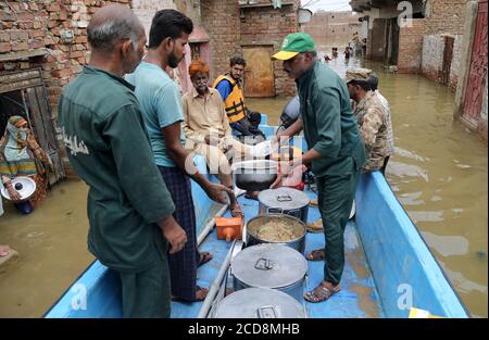 Hyderabad, Pakistan. 27th Aug, 2020. Rescue workers of Silani Welfare are distributing foods among the flood affected families of Maher Ali colony (Photo by Jan Ali Laghari/Pacific Press) Credit: Pacific Press Media Production Corp./Alamy Live News Stock Photo