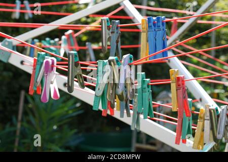 Closeup of colored clothespins on a clothesline Stock Photo
