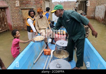 Hyderabad, Pakistan. 27th Aug, 2020. Rescue workers of Silani Welfare are distributing foods among the flood affected families of Maher Ali colony (Photo by Jan Ali Laghari/Pacific Press/Sipa USA) Credit: Sipa USA/Alamy Live News Stock Photo