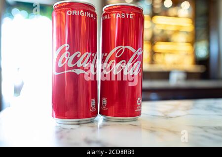 ASSISI, ITALY - AUGUST 22, 2020: Cold Coca-Cola cans on a table in a bar. Coca-Cola, or Coke, is a carbonated soft drink manufactured by The Coca-Cola Stock Photo