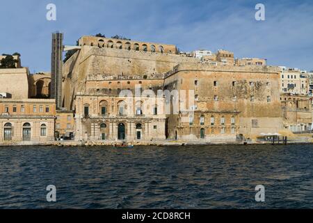 Valletta waterfront and city walls with Barrakka Lift seen from Grand Harbour, Malta Stock Photo