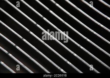 Dark gray metal grating in low light technique Stock Photo
