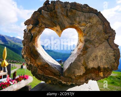 Visp, Switzerland: The Dom mountain (4545 m) through a wooden heart Stock Photo