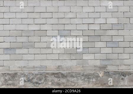 Gray old brick wall, stones in a row. Close-up Stock Photo
