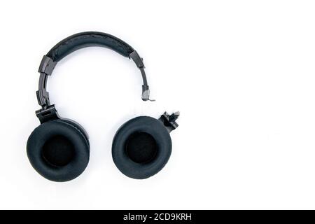 Broken headphones isolated on white background. Wireless headphone