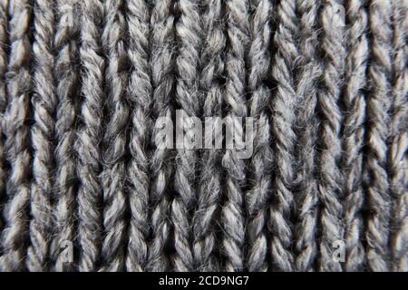 Grey ribbed knitted wool background texture macro with selective focus Stock Photo