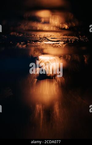 orange lights of a street lamp after rain, beautiful bokeh background Stock Photo