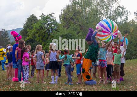Kamennomostsky, Russia - September 1, 2018: Animators entertain children on the feast day of the village of Kamennomostskiy in the autumn Park Stock Photo