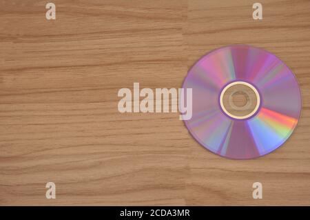 CD disk come on wooden background for recording photos and data Stock Photo