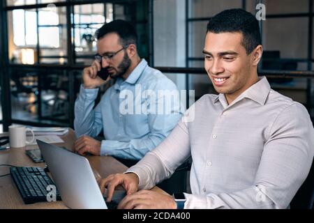 Two men sitting in office and working together Stock Photo