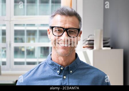Smiling Man Portrait At Workplace In Office Stock Photo