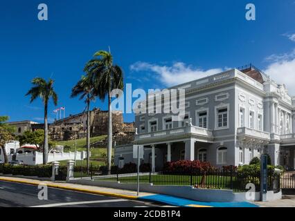 The Antiguo Casino of San Juan was built in 1917 in the Beaux Arts style as a social club.  Behind is the historic Castillo San Cristobal, which is a Stock Photo