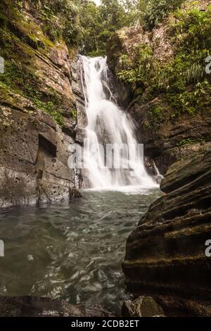 La Mina Falls or Cascada la Mina in the rainforest of El Yunque National Forest in Puerto Rico. Stock Photo