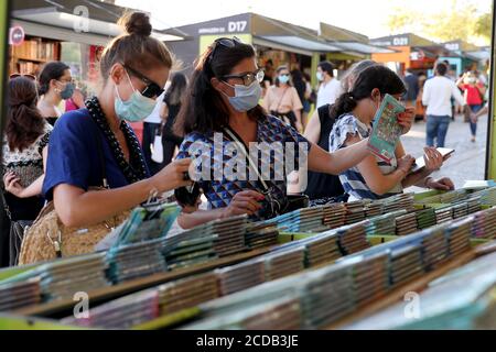 Lisbon, Portugal. 27th Aug, 2020. People visit the Lisbon Book Fair 2020 at the Parque Eduardo VII in Lisbon, Portugal on August 27, 2020. The 90th edition of the Lisbon Book Fair, originally scheduled for May/June, will be held from August 27 to September 13, due to the Covid-19 pandemic. Credit: Pedro Fiuza/ZUMA Wire/Alamy Live News Stock Photo