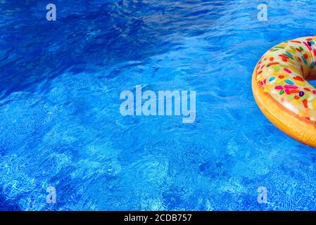 Detail with copy space of a round float in a pool with clean and refreshing waters, background with negative space for summer. Stock Photo
