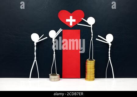 Stick figure reaching for a red heart shape with cross cutout while stepping on stack of coins. Healthcare, medical care and hospital access inequality. Stock Photo