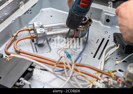 man fixing a gas cooker Stock Photo