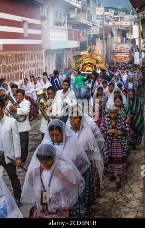 Women carry the image of the Virgin in the Catholic procession of the Virgin of Carmen in San Pedro la Laguna, Guatemala. Stock Photo