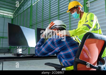The sad feeling of engineering in the warehouse and worker Stock Photo