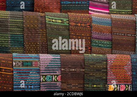 A display of tzutes or traditional utility cloths for sale in the weekly open market in Santiago Atitlan, Guatemala.  They are hand made on a traditio Stock Photo