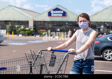Flowood, MS / USA - August 8, 2020 - Young Woman wears face mask while shopping at Lowe's during pandemic Stock Photo