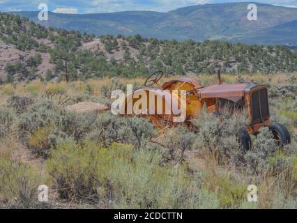 Old Abandoned, antique tractor in the countryside of Colorado Stock Photo